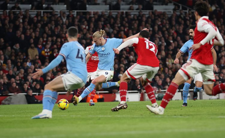 LONDON, ENGLAND - FEBRUARY 15: Erling Haaland of Manchester City scores the team's third goal during the Premier League match between Arsenal FC and Manchester City at Emirates Stadium on February 15, 2023 in London, England. (Photo by Julian Finney/Getty Images)