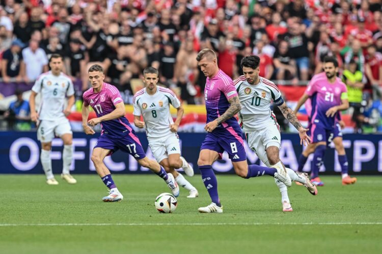 STUTTGART, GERMANY - JUNE 19: Toni Kroos of Germany and Dominik Szoboszlai of Hungary battle for the ball during the UEFA EURO 2024 group stage match between Germany and Hungary at Stuttgart Arena on June 19, 2024 in Stuttgart, Germany. (Photo by Harry Langer/DeFodi Images via Getty Images)