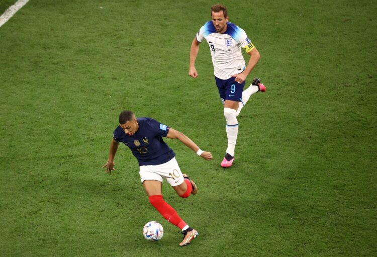 AL KHOR, QATAR - DECEMBER 10: Kylian Mbappe of France controls the ball against Harry Kane of England during the FIFA World Cup Qatar 2022 quarter final match between England and France at Al Bayt Stadium on December 10, 2022 in Al Khor, Qatar. (Photo by Robert Cianflone/Getty Images)